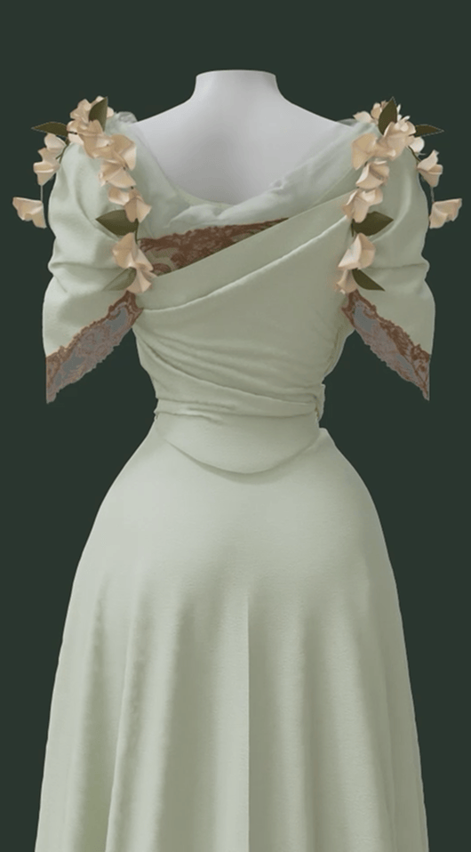A close up of the back of a 3 dimensional rendering of the Worth Dress, showing its separate mint green skirt and bodice with surface decorations of cotton lace and morning glory flowers. The backline features silk netting and three-inch wide lace with an irregular edge.