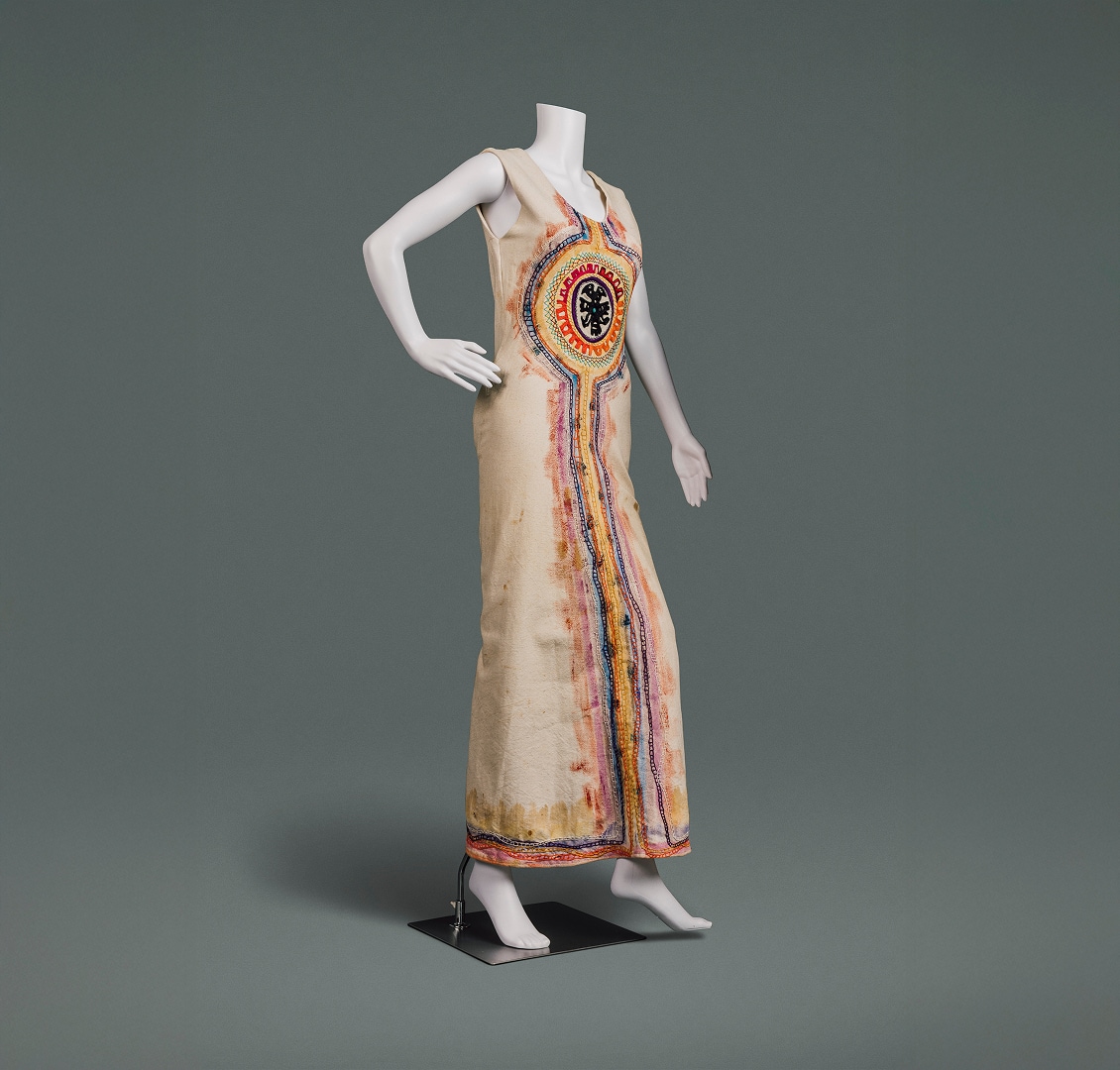 A full-length natural cotton shift decorated with painting and embroidery influenced by folk art traditions.