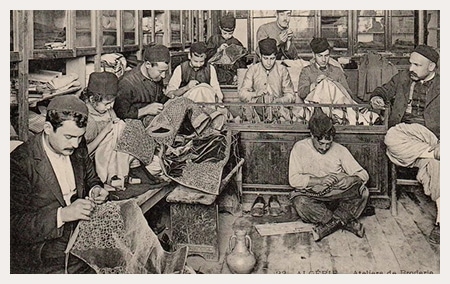 A group of Algerian men sit embroidering.
