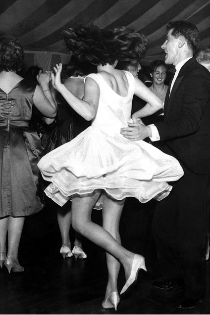 A woman letting her hair down, dancing to Sixties music with her skirt flaring up all round her.