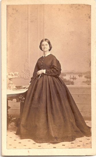 Sepia portrait of Emily Crooks in conservative Victorian era dress.