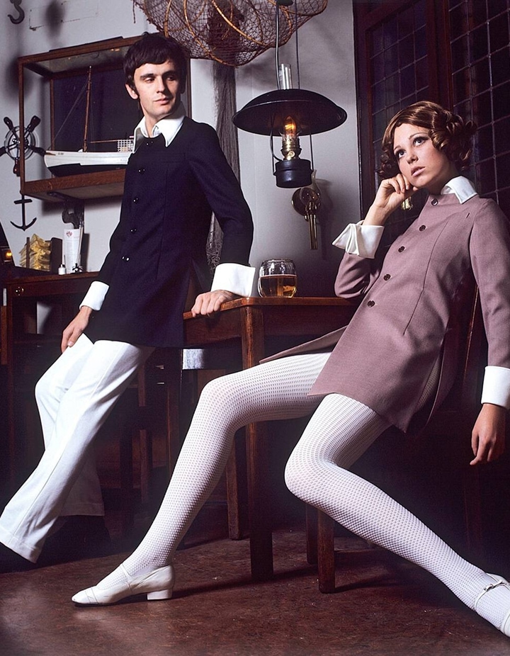 Model and designer Sighsten Herrgårddressed in a black jacket and white trousers, and an unknown woman in a jacket with stocking like trousers.